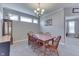 Cozy dining room featuring neutral walls, a wood table with six chairs, and a decorative chandelier at 1476 Anon Ct, Greenwood, IN 46143