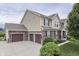 Beautiful home featuring a three-car garage, stone accents, and well-maintained landscaping at 1476 Anon Ct, Greenwood, IN 46143
