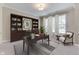 Stylish home office with custom built-ins, a large desk, and comfortable seating at 1476 Anon Ct, Greenwood, IN 46143