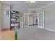 Large playroom featuring French doors, a shelving unit, and plush carpet at 1476 Anon Ct, Greenwood, IN 46143