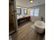 Bright bathroom with double vanity, vessel sinks, modern fixtures, and a soaking tub at 1512 Bellefontaine St, Indianapolis, IN 46202