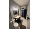 Cozy bathroom featuring a vanity with white basin, commode, and marble-style tile floor at 1512 Bellefontaine St, Indianapolis, IN 46202