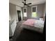 Bedroom with pink accents, two windows, and a ceiling fan at 1512 Bellefontaine St, Indianapolis, IN 46202