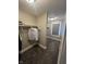 Carpeted walk-in closet providing ample storage with shelving and rod, illuminated by modern ceiling light at 1512 Bellefontaine St, Indianapolis, IN 46202