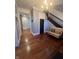 Bright foyer with dark wood flooring, high ceilings, chandelier, dark staircase, and a cozy bench at 1512 Bellefontaine St, Indianapolis, IN 46202
