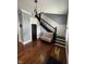 Elegant foyer with dark wood staircase, beautiful flooring, wainscoting, modern chandelier, and a cozy bench at 1512 Bellefontaine St, Indianapolis, IN 46202
