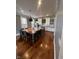 Open-concept kitchen boasts a large island, white cabinets, pendant lights, and wood flooring at 1512 Bellefontaine St, Indianapolis, IN 46202
