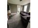 Comfortable living room featuring a large sectional sofa and natural light through two windows at 1512 Bellefontaine St, Indianapolis, IN 46202