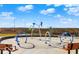Park splashpad with colorful play equipment and seating for Gathering fun on a sunny day at 1512 Bellefontaine St, Indianapolis, IN 46202