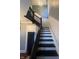 Elegant staircase featuring dark wood accents, white wainscoting, and ample natural light at 1512 Bellefontaine St, Indianapolis, IN 46202
