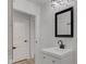 Bathroom with white vanity, black framed mirror, and modern faucet at 1517 Wallace Ave, Indianapolis, IN 46201