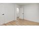 Bedroom featuring wood-look floors, two white doors, and white walls at 1517 Wallace Ave, Indianapolis, IN 46201