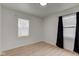 Bedroom featuring wood-look floors, two windows, and dark curtains at 1517 Wallace Ave, Indianapolis, IN 46201