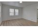 Minimalist bedroom featuring hardwood flooring and abundant natural light from a large window at 1517 Wallace Ave, Indianapolis, IN 46201