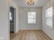 Modern dining area featuring hardwood floors and an elegant chandelier above the room at 1517 Wallace Ave, Indianapolis, IN 46201