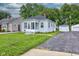 Inviting bungalow with a cozy front porch, landscaped lawn, and detached garage at 1517 Wallace Ave, Indianapolis, IN 46201