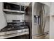 Close-up of stainless steel appliances in the kitchen, including a refrigerator and gas stove at 1517 Wallace Ave, Indianapolis, IN 46201