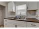 Modern kitchen featuring white cabinets, sleek hardware, and butcher block counters at 1517 Wallace Ave, Indianapolis, IN 46201