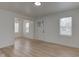 Bright living room with hardwood floors, fresh paint, and lots of windows for natural light at 1517 Wallace Ave, Indianapolis, IN 46201
