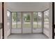 Bright and airy sunroom with multiple windows and a neutral color palette at 1517 Wallace Ave, Indianapolis, IN 46201