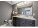 Bathroom features a double sink vanity, granite countertops, and a large mirror with great lighting at 15369 Mystic Rock Dr, Carmel, IN 46033
