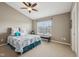 Cozy bedroom with ceiling fan, large window, and golf clubs at 15369 Mystic Rock Dr, Carmel, IN 46033