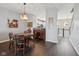 Cozy dining area featuring wood floors and a stylish wooden table, adjacent to a convenient wine storage unit at 15369 Mystic Rock Dr, Carmel, IN 46033