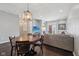 Stylish dining area with a modern chandelier, a wood table, and seamless access to the living room at 15369 Mystic Rock Dr, Carmel, IN 46033