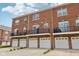 Exterior of brick apartment complex with second floor balconies and one car garages at 15369 Mystic Rock Dr, Carmel, IN 46033