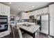 Modern kitchen with white cabinets, granite countertops, stainless steel appliances and a central island with bar stools at 15369 Mystic Rock Dr, Carmel, IN 46033