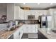 Well-lit kitchen with white cabinets, granite countertops, stainless steel appliances, and a stylish tile backsplash at 15369 Mystic Rock Dr, Carmel, IN 46033