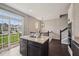 Bright kitchen with an island and access to a balcony offering pleasant views and seamless indoor-outdoor living at 15369 Mystic Rock Dr, Carmel, IN 46033