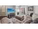 Inviting living room with a fireplace, large sectional sofa, and access to an outdoor balcony at 15369 Mystic Rock Dr, Carmel, IN 46033