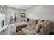 Comfortable living room featuring a large sectional sofa and natural light from the balcony at 15369 Mystic Rock Dr, Carmel, IN 46033