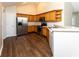 Well-lit kitchen featuring wood cabinets, stainless steel appliances, and hardwood floors at 16628 Brownstone Ct, Westfield, IN 46074