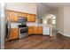 Bright kitchen boasts stainless steel appliances, wood cabinets, and hardwood flooring at 16628 Brownstone Ct, Westfield, IN 46074