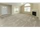 Spacious living room with fireplace, large windows, and neutral-toned carpeting at 16628 Brownstone Ct, Westfield, IN 46074