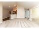 Carpeted living space featuring an open layout with a view of the kitchen and connecting hallways at 16628 Brownstone Ct, Westfield, IN 46074