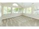 Bright sunroom filled with natural light from numerous windows, featuring neutral carpeting at 16628 Brownstone Ct, Westfield, IN 46074