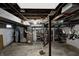 Unfinished basement with exposed ductwork, storage shelving, and concrete floor, ready for customization at 1717 W 10Th St, Anderson, IN 46016