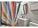 Stylish bathroom with a modern vanity, colorful shower curtain, and bright lighting at 1717 W 10Th St, Anderson, IN 46016