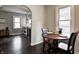 Cozy dining area with hardwood floors and a charming round table, with a view into the living room through an arched doorway at 1717 W 10Th St, Anderson, IN 46016