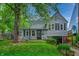 Charming two-story home with a well-maintained lawn, mature trees, and a welcoming front entrance at 1717 W 10Th St, Anderson, IN 46016