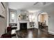 The main living area features hardwood floors and a charming fireplace with built-in shelving on both sides, offering lots of light at 1717 W 10Th St, Anderson, IN 46016