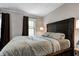Comfortable main bedroom with a large bed, wood headboard, and ambient lighting at 1717 W 10Th St, Anderson, IN 46016