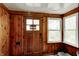 The Mud Room features wood-paneled walls and ample natural light from the adjacent windows, offering a cozy transition space at 1717 W 10Th St, Anderson, IN 46016
