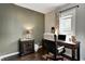 Functional home office with a wooden desk, comfortable chair, and natural light at 1717 W 10Th St, Anderson, IN 46016