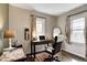 Bright home office with a wooden desk, comfortable chair, and natural light at 1717 Hst W 10Th St, Anderson, IN 46016