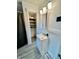 Bright bathroom with a modern vanity, stylish lighting, and a storage closet for optimal organization at 1806 Union St, Columbus, IN 47201