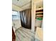 A functional bathroom with a shower, toilet, sink, and built-in shelving for storage at 1806 Union St, Columbus, IN 47201